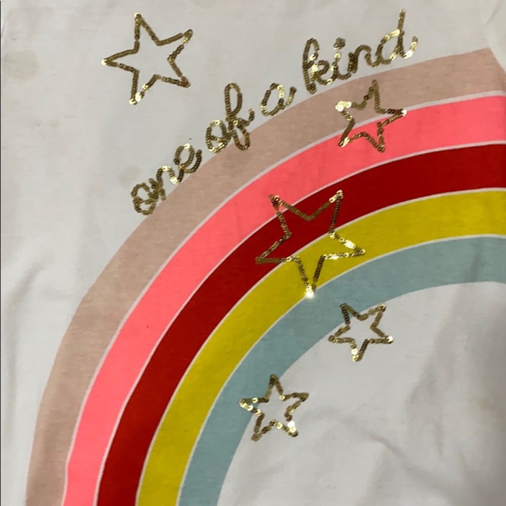 A white t-shirt with a rainbow and words across it